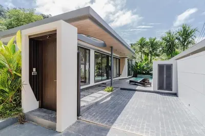 a villa with a entrance to a house at Pangolin villa Nai Thon Beach in Nai Thon Beach