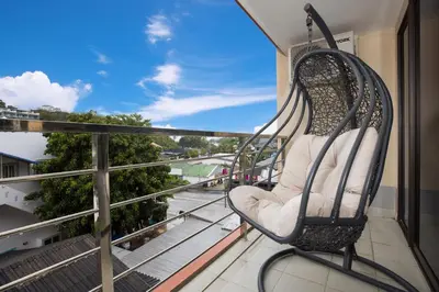 a swinging chair on a balcony with a view at Rawai Apartment RBC 311, near Famous Rawai Market in Phuket Town