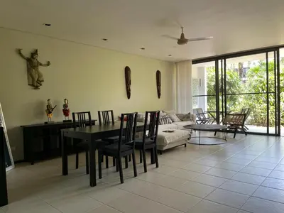 a living room with a table and a couch at Secret Garden at Bangtao Beach in Surin Beach