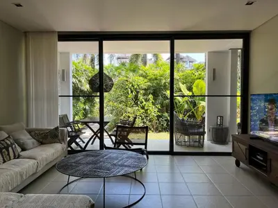 a living room with a couch and a table at Secret Garden at Bangtao Beach in Surin Beach
