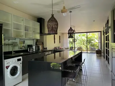 a kitchen with a washer and dryer on a counter at Secret Garden at Bangtao Beach in Surin Beach