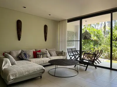 a living room with a couch and a table at Secret Garden at Bangtao Beach in Surin Beach