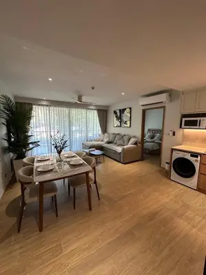 a living room with a couch and a table at Laguna Beachside Residences 2bdr in Ban Thalat Choeng Thale