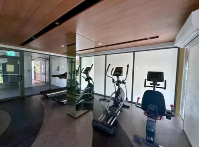 a gym with two treadmills and two exercise bikes at Laguna Beachside Residences 2bdr in Ban Thalat Choeng Thale