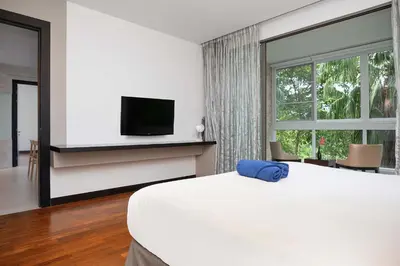 a bedroom with a bed and a tv and a window at Stylish Stay, Quiet Vibe - Apartment RGN B411 in Bangtao in Bang Tao Beach