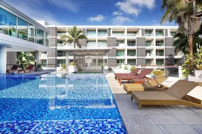 a swimming pool with lounge chairs and a building at Stylish Stay, Quiet Vibe - Apartment RGN B411 in Bangtao in Bang Tao Beach