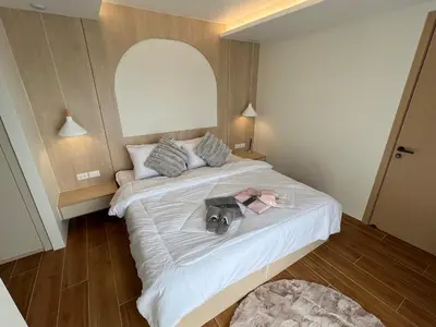 a bedroom with a bed with a camera on it at FANTASEA KAMALA NEW 1 BEDROOM & Living Room Balcony in Kamala Beach