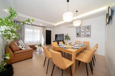 a dining room and living room with a table and chairs at Beachside Patong 50m or less min walk in Patong Beach