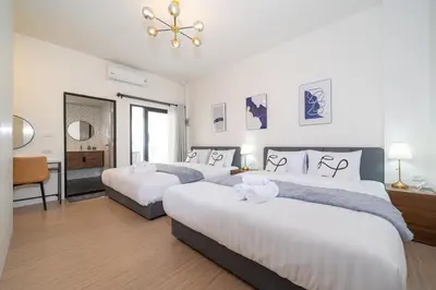 a bedroom with three beds and a mirror at Beachside Patong 50m or less min walk in Patong Beach