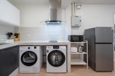 a kitchen with a washing machine and a washer at Beachside Patong 50m or less min walk in Patong Beach
