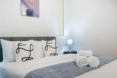 a bedroom with a bed with black and white pillows at Beachside Patong 50m or less min walk in Patong Beach