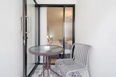 a small table and a chair in a room at Beachside Patong 50m or less min walk in Patong Beach