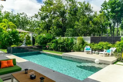 a swimming pool in the backyard of a house at Botanica Modern Loft by RESAVA in Bang Tao Beach