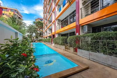 a swimming pool in the middle of a building at апартаменты NBC Nai Harn in Rawai Beach