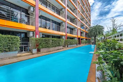 a swimming pool in front of a building at апартаменты NBC Nai Harn in Rawai Beach