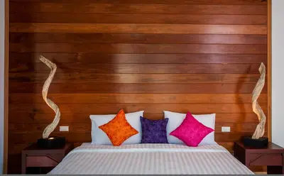 a bedroom with a bed with colorful pillows at Paradise Resort Phi Phi in Phi Phi Don