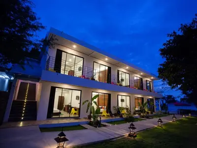 a large white house with a balcony at night at Paradise Resort Phi Phi in Phi Phi Don