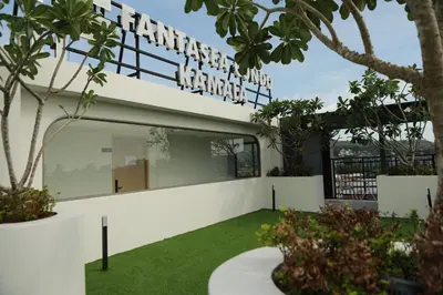 a white building with a sign that reads infinity garden at Apartment by the sea Kamala Beach A502 in Kamala Beach