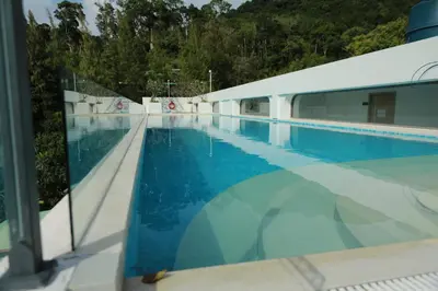 a swimming pool next to a building at Apartment by the sea Kamala Beach A502 in Kamala Beach