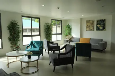 a living room with a couch and chairs and tables at Apartment by the sea Kamala Beach A502 in Kamala Beach