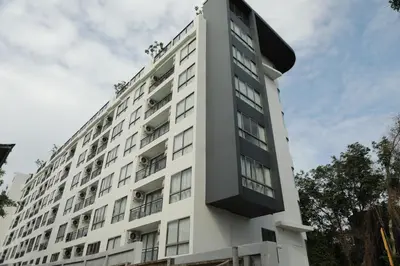 a tall white building with windows on it at Apartment near the sea Kamala beach 601 in Kamala Beach