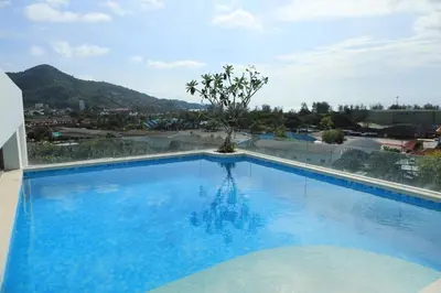 a large swimming pool with a view of a city at Apartment near the sea Kamala beach 601 in Kamala Beach