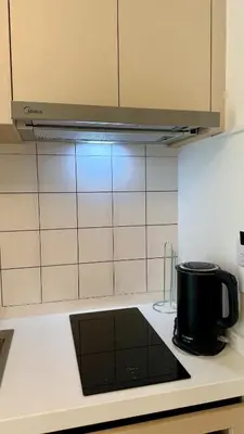 a black pot on a stove in a kitchen at Apartment near the sea Kamala beach 601 in Kamala Beach