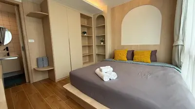 a bedroom with two folded towels on a bed at Apartment near the sea Kamala beach 601 in Kamala Beach