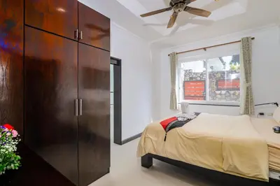 a bedroom with a bed and a dresser at Luxurious & Quiet Pool Villa Orchid in Nai Yang Beach