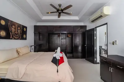 a bedroom with a bed and a ceiling fan at Luxurious & Quiet Pool Villa Orchid in Nai Yang Beach