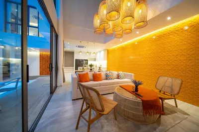 a living room with a couch and a table at Coconus Pool Villa \u963f\u4e3d\u838e \u6cf3\u6c60\u522b\u5885 in Ban Pak Lak