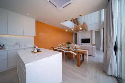 a kitchen and living room with a table and a dining room at Coconus Pool Villa \u963f\u4e3d\u838e \u6cf3\u6c60\u522b\u5885 in Ban Pak Lak