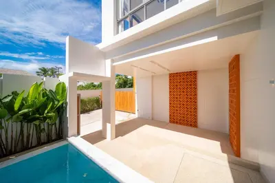 a villa with a swimming pool and a house at Coconus Pool Villa \u963f\u4e3d\u838e \u6cf3\u6c60\u522b\u5885 in Ban Pak Lak