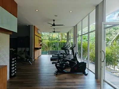 a gym with treadmills and elliptical machines at Kamala Natural Modern ApartmentHigh Speed WiFiBig Living Room in Kamala Beach