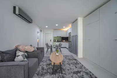 a living room with a couch and a table at Kamala Natural Modern ApartmentHigh Speed WiFiBig Living Room in Kamala Beach