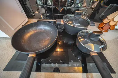 a stove with two pans and a pot on it at Kamala Natural Modern ApartmentHigh Speed WiFiBig Living Room in Kamala Beach