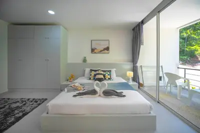 a bedroom with a bed with two swans on it at Kamala Natural Modern ApartmentHigh Speed WiFiBig Living Room in Kamala Beach