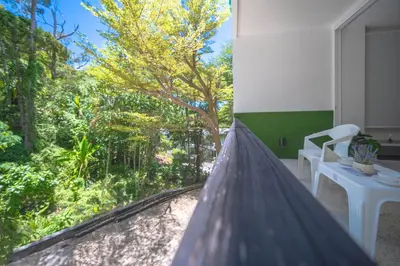 a view from a room with a window with trees at Kamala Natural Modern ApartmentHigh Speed WiFiBig Living Room in Kamala Beach