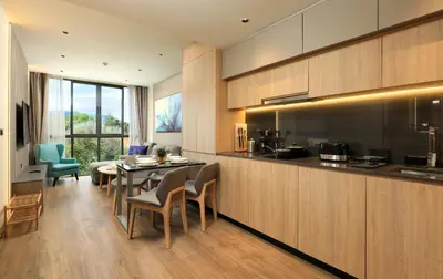a kitchen and living room with a table and chairs at New 1bdr Apartment Layan C518 in Ko Kala
