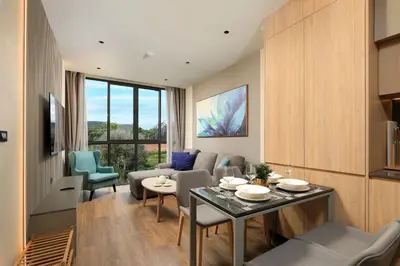 a living room with a couch and a table and chairs at New 1bdr Apartment Layan C518 in Ko Kala