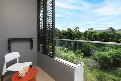 a white chair sitting on a balcony with a large window at New 1bdr Apartment Layan C518 in Ko Kala