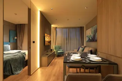a hotel room with a bed and a table and chairs at New 1bdr Apartment Layan C518 in Ko Kala