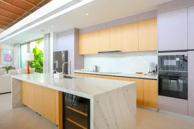 a kitchen with a large island with a counter top at Asherah Villa By Asherah Team in Ban Phru Champa