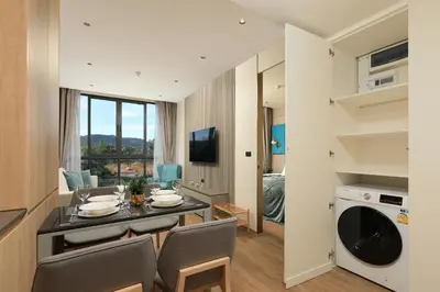 a kitchen and dining room with a table and chairs at New 1 bdr Apartment near Layan beach C610 in Ko Kala
