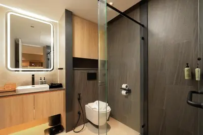 a bathroom with a toilet and a glass shower at New 1 bdr Apartment near Layan beach C610 in Ko Kala