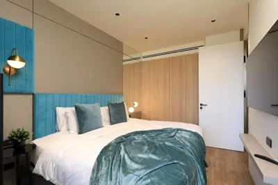 a bedroom with a large white bed with blue accents at New 1 bdr Apartment near Layan beach C610 in Ko Kala