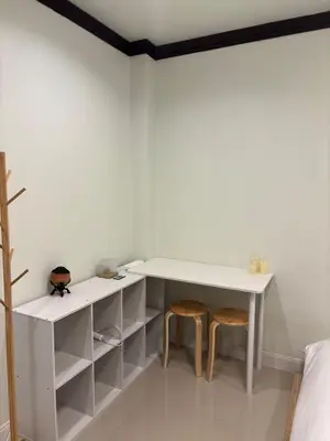 a room with a white desk and two stools at Spacious and cozy Thai House in Ban Bang Khu