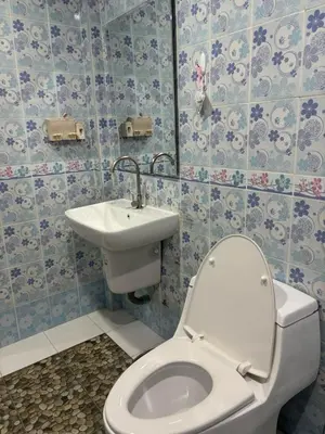 a bathroom with a toilet and a sink at Spacious and cozy Thai House in Ban Bang Khu