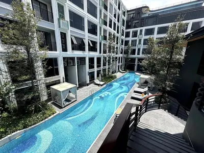 a swimming pool in the middle of a building at Bellevue lagoon 20 units in Laguna Phuket
