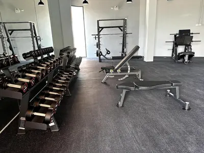 a gym with rows of treadmills and machines at Bellevue lagoon 20 units in Laguna Phuket